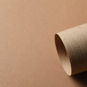Rolled sheet on craft background, close up and space for text