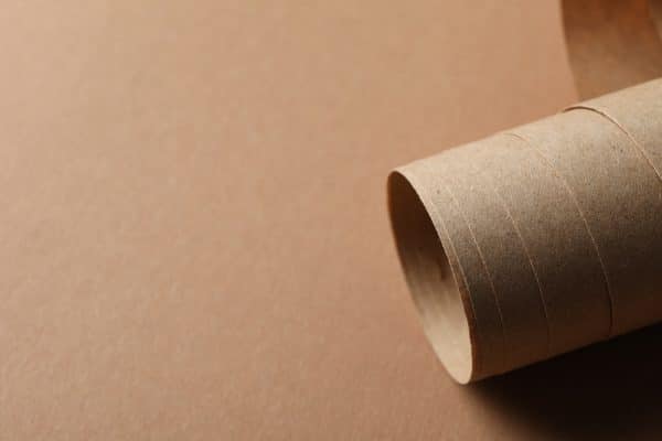 Rolled sheet on craft background, close up and space for text
