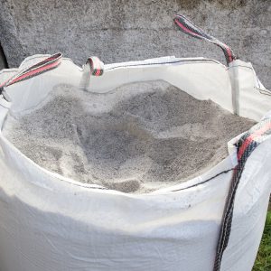 Sack full of gray construction sand