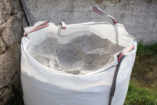 Sack full of gray construction sand